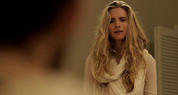 Movie still from “Sound of My Voice” (2011), directed by Zal Batmanglij – A woman with long blonde hair wearing a white dress; Close Up shot, Over the shoulder angle