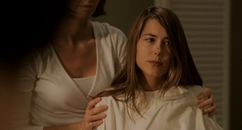 Movie still from “Sound of My Voice” (2011), directed by Zal Batmanglij – A woman is getting her hair cut by a stylist; Close Up shot, Over the shoulder angle
