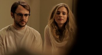 Movie still from “Sound of My Voice” (2011), directed by Zal Batmanglij – A man and a woman are looking in a mirror; Close Up shot, Over the shoulder angle