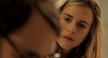 Movie still from “Sound of My Voice” (2011), directed by Zal Batmanglij – A person looking at a camera; Close Up shot, Over the shoulder angle
