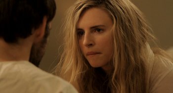 Movie still from “Sound of My Voice” (2011), directed by Zal Batmanglij – A person with long blonde hair; Close Up shot, Over the shoulder angle