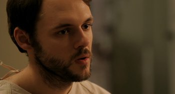 Movie still from “Sound of My Voice” (2011), directed by Zal Batmanglij – A person with a beard; Close Up shot, Over the shoulder angle