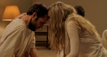 Movie still from “Sound of My Voice” (2011), directed by Zal Batmanglij – A man and a woman kissing in a room; Medium shot, Over the shoulder angle