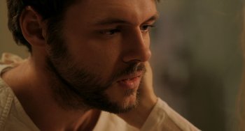 Movie still from “Sound of My Voice” (2011), directed by Zal Batmanglij – A person with a beard; Close Up shot, Over the shoulder angle