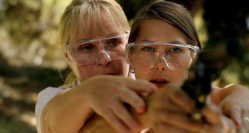 Movie still from “Sound of My Voice” (2011), directed by Zal Batmanglij – Two women wearing safety goggles and one is pointing at the camera; Close Up shot, Over the shoulder angle