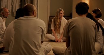 Movie still from “Sound of My Voice” (2011), directed by Zal Batmanglij – A woman sitting on the ground with two men; Medium shot, Over the shoulder angle