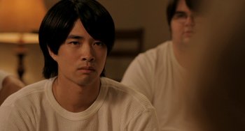 Movie still from “Sound of My Voice” (2011), directed by Zal Batmanglij – A man sitting next to another man in a room; Close Up shot, Over the shoulder angle