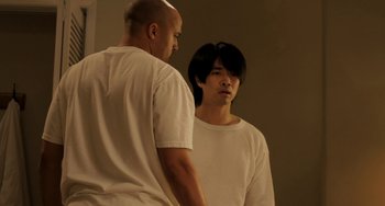 Movie still from “Sound of My Voice” (2011), directed by Zal Batmanglij – Two men standing next to each other in front of a mirror; Medium shot, Over the shoulder angle