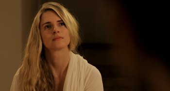 Movie still from “Sound of My Voice” (2011), directed by Zal Batmanglij – A beautiful blonde haired woman wearing a white shirt; Close Up shot, Over the shoulder angle
