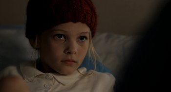 Movie still from “Sound of My Voice” (2011), directed by Zal Batmanglij – A little girl wearing a red knitted hat; Close Up shot, High angle