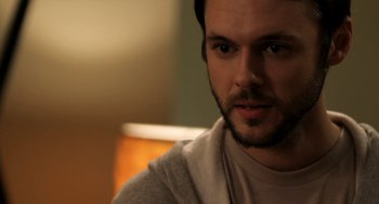 Movie still from “Sound of My Voice” (2011), directed by Zal Batmanglij – A person with a beard looking at the camera; Close Up shot, Over the shoulder angle