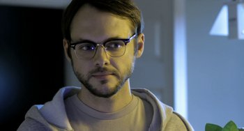 Movie still from “Sound of My Voice” (2011), directed by Zal Batmanglij – A person wearing glasses; Close Up shot, Over the shoulder angle