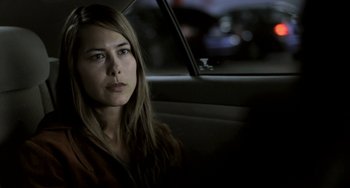 Movie still from “Sound of My Voice” (2011), directed by Zal Batmanglij – A woman sitting in the back seat of a car; Close Up shot, Over the shoulder angle