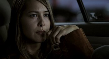 Movie still from “Sound of My Voice” (2011), directed by Zal Batmanglij – A woman sitting in the back seat of a car; Close Up shot, Over the shoulder angle