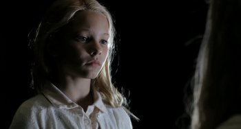 Movie still from “Sound of My Voice” (2011), directed by Zal Batmanglij – A young girl with long blonde hair wearing a white shirt; Close Up shot, Low angle