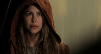 Movie still from “Sound of My Voice” (2011), directed by Zal Batmanglij – A woman wearing a brown hooded jacket looking at the camera; Close Up shot, Over the shoulder angle