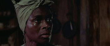 Movie still from “Sounder” (1972), directed by Martin Ritt – A person wearing a headscarf; Close Up shot, Low angle