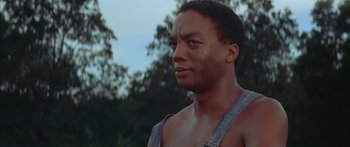 Movie still from “Sounder” (1972), directed by Martin Ritt – A person wearing a bib; Close Up shot, Low angle