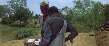 Movie still from “Sounder” (1972), directed by Martin Ritt – A man and a woman standing next to each other in a field; Medium shot, Over the shoulder angle