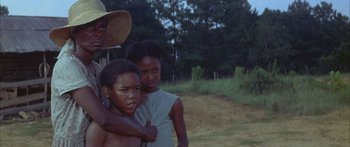 Movie still from “Sounder” (1972), directed by Martin Ritt – A couple of people standing next to each other; Medium shot, Low angle