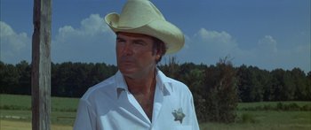 Movie still from “Sounder” (1972), directed by Martin Ritt – A man wearing a white shirt and a cowboy hat; Close Up shot, Low angle