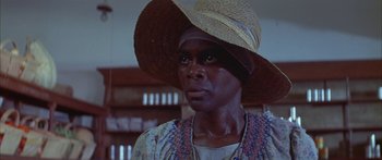 Movie still from “Sounder” (1972), directed by Martin Ritt – A person wearing a straw hat; Close Up shot, Low angle