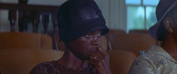 Movie still from “Sounder” (1972), directed by Martin Ritt – An older woman wearing a black hat sitting in a room; Close Up shot, High angle