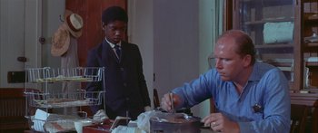 Movie still from “Sounder” (1972), directed by Martin Ritt – Two men sitting at a dining room table; Medium shot, Low angle