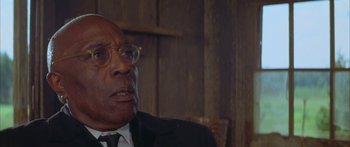 Movie still from “Sounder” (1972), directed by Martin Ritt – An older man wearing a suit and tie; Close Up shot, Low angle