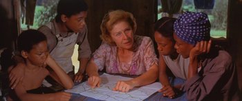 Movie still from “Sounder” (1972), directed by Martin Ritt – An older woman sitting at a table looking at a map with two young children; Medium shot, Over the shoulder angle