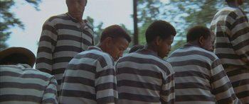 Movie still from “Sounder” (1972), directed by Martin Ritt – A group of young men standing next to each other; Medium shot, High angle