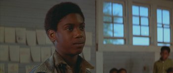 Movie still from “Sounder” (1972), directed by Martin Ritt – A young man is looking into the distance; Close Up shot, Low angle