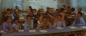 Movie still from “Sounder” (1972), directed by Martin Ritt – A group of children sitting at a table in a classroom; Medium shot, High angle