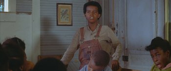 Movie still from “Sounder” (1972), directed by Martin Ritt – A young man standing next to another young man; Medium shot, Low angle