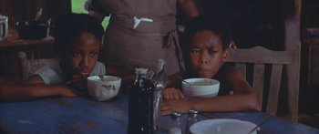 Movie still from “Sounder” (1972), directed by Martin Ritt – A group of children sitting at a table with bowls of food; Close Up shot, High angle