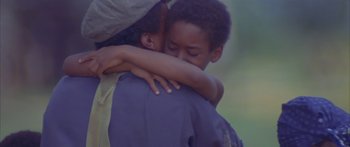 Movie still from “Sounder” (1972), directed by Martin Ritt – A young boy is hugging his father outside; Close Up shot, Low angle