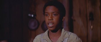 Movie still from “Sounder” (1972), directed by Martin Ritt – A young man in a yellow shirt is looking at the camera; Close Up shot, High angle