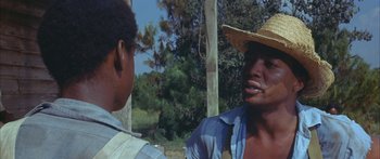 Movie still from “Sounder” (1972), directed by Martin Ritt – Two men talking to each other in a straw hat; Close Up shot, Over the shoulder angle