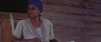 Movie still from “Sounder” (1972), directed by Martin Ritt – An african american woman wearing a blue head scarf; Close Up shot, Low angle