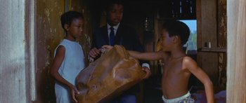 Movie still from “Sounder” (1972), directed by Martin Ritt – A group of young men standing next to each other; Medium shot, High angle