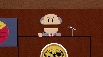 Movie still from “South Park: Bigger, Longer & Uncut” (1999), directed by Trey Parker – A cartoon of a man in a suit sitting at a podium with a microphone in front of him; Medium shot, Low angle