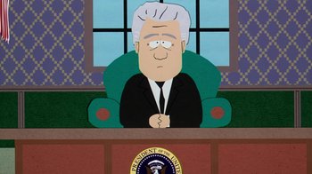 Movie still from “South Park: Bigger, Longer & Uncut” (1999), directed by Trey Parker – The president of the united states of america sitting at the president's desk; Medium shot, Low angle