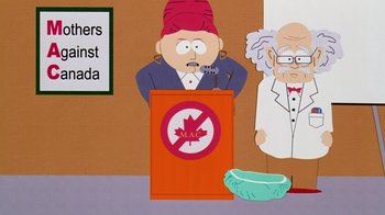 Movie still from “South Park: Bigger, Longer & Uncut” (1999), directed by Trey Parker – A man in a red hat is speaking at a podium; Medium shot, High angle
