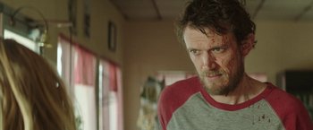 Movie still from “Southbound” (2015), directed by Tyler Gillett – A person with a bruised face; Close Up shot, Over the shoulder angle