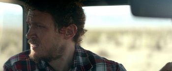 Movie still from “Southbound” (2015), directed by Tyler Gillett – A person's face in a vehicle; Close Up shot, Over the shoulder angle