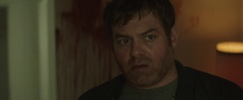 Movie still from “Southbound” (2015), directed by Tyler Gillett – A person wearing a jacket; Close Up shot, Over the shoulder angle