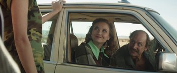 Movie still from “Southbound” (2015), directed by Tyler Gillett – A woman sitting in the driver's seat of a car; Medium shot, Low angle