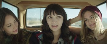 Movie still from “Southbound” (2015), directed by Tyler Gillett – A young woman sitting in the back seat of a car; Close Up shot, Over the shoulder angle