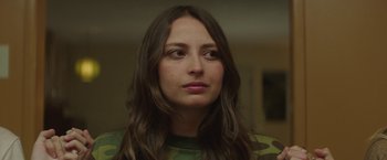 Movie still from “Southbound” (2015), directed by Tyler Gillett – A person with long brown hair; Close Up shot, Over the shoulder angle