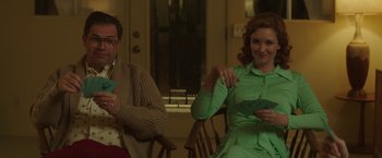 Movie still from “Southbound” (2015), directed by Tyler Gillett – A man and a woman sitting in a room; Medium shot, Over the shoulder angle